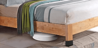 A bed equipped with furniture raisers