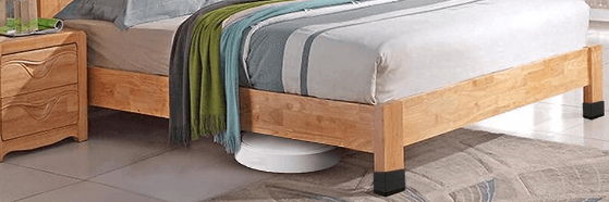 A bed equipped with furniture raisers