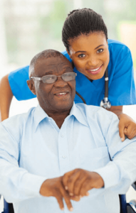 A nurse helping elderly to stand up