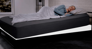 A woman sleeping in an elevated matress