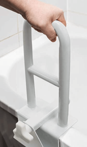 a hand holding a Bathtub rail to move to the bath