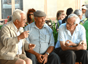 two men talking to a senior